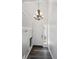 Bright foyer with a stylish chandelier, hardwood floors, and a convenient coat rack at 5193 E 119Th Way, Thornton, CO 80233