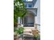 Inviting front porch with stone accents and a well-landscaped garden, leading to the front door at 5193 E 119Th Way, Thornton, CO 80233
