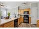 Functional kitchen with modern appliances, wooden cabinets, and a breakfast bar overlooking the dining area at 5193 E 119Th Way, Thornton, CO 80233