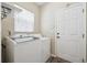 Bright laundry room with a window, washer, dryer, and convenient access to the exterior at 5193 E 119Th Way, Thornton, CO 80233