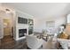 Bright living room featuring a fireplace, built-in shelving, and comfortable seating at 5193 E 119Th Way, Thornton, CO 80233
