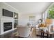 Cozy living room featuring a fireplace, built-in shelving, and comfortable seating at 5193 E 119Th Way, Thornton, CO 80233