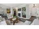 Cozy living room with a fireplace, built-in shelves, and seamless flow to the kitchen at 5193 E 119Th Way, Thornton, CO 80233