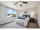 Cozy main bedroom with neutral walls, carpet, and a window overlooking a green outdoor landscape at 5193 E 119Th Way, Thornton, CO 80233