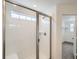 Bathroom featuring a shower with a glass door and white subway tile, and a view of a closet at 4592 Windmill Dr, Brighton, CO 80601