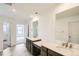 Modern bathroom with double sinks, grey marble flooring, and bright natural light at 4592 Windmill Dr, Brighton, CO 80601