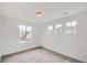 Bright bedroom with neutral carpet and three windows offering natural light at 4592 Windmill Dr, Brighton, CO 80601