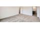 Neutral carpeted bedroom with doorway to bathroom and walk-in closet at 4592 Windmill Dr, Brighton, CO 80601