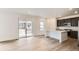 Open kitchen/dining area with dark cabinets, stainless steel appliances, island, and sliding doors to backyard at 4592 Windmill Dr, Brighton, CO 80601