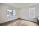 Bright living room featuring hardwood flooring and several windows providing natural light at 4592 Windmill Dr, Brighton, CO 80601