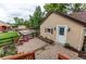Backyard view featuring guest house, patio, and lush landscaping at 7785 W 5Th Ave, Lakewood, CO 80226