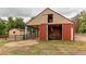 Exterior of barn with sliding door, mower, and shed at 7785 W 5Th Ave, Lakewood, CO 80226