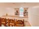 Basement bar with built-in shelves, window and counter seating at 7785 W 5Th Ave, Lakewood, CO 80226
