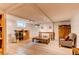 Finished basement with light-colored floors, a brick fireplace, track lighting, and a seating area at 7785 W 5Th Ave, Lakewood, CO 80226