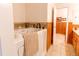 Updated bathroom showcasing a walk-in tub, tiled floors, and wainscoting at 7785 W 5Th Ave, Lakewood, CO 80226