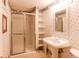 Bathroom featuring walk-in shower, shelving and pedestal sink at 7785 W 5Th Ave, Lakewood, CO 80226