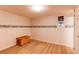 Small bedroom with wood-look floors, neutral walls, a decorative wallpaper border, and a storage trunk at 7785 W 5Th Ave, Lakewood, CO 80226