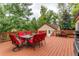 Spacious wooden deck with outdoor dining furniture, grill, and views of the backyard at 7785 W 5Th Ave, Lakewood, CO 80226