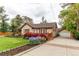 Charming single Gathering home with a detached garage, front porch, and landscaped yard at 7785 W 5Th Ave, Lakewood, CO 80226