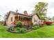 Charming single Gathering home with a front porch, landscaped yard, and brick chimney at 7785 W 5Th Ave, Lakewood, CO 80226