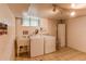 Bright laundry room with sink, washer, dryer and storage cabinet at 7785 W 5Th Ave, Lakewood, CO 80226