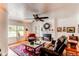 Cozy living room featuring a fireplace, hardwood floors, and plenty of natural light at 7785 W 5Th Ave, Lakewood, CO 80226