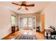 Bright living room featuring hardwood floors, a ceiling fan, and French doors to the outside deck at 7785 W 5Th Ave, Lakewood, CO 80226
