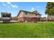 Large backyard with a patio, hot tub, and a spacious lawn at 7784 Lewis St, Arvada, CO 80005