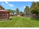 Well-maintained backyard with manicured lawn and shed at 7784 Lewis St, Arvada, CO 80005