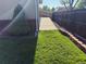 Well-maintained backyard features a lush lawn, brick border, and a convenient ramp leading to a fenced area at 7784 Lewis St, Arvada, CO 80005