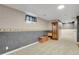 Partially finished basement with wainscoting and ample room for storage or recreation at 7784 Lewis St, Arvada, CO 80005
