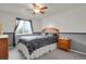 Cozy bedroom with a queen bed, ceiling fan, and natural light from the window at 7784 Lewis St, Arvada, CO 80005