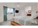 Bright bedroom features large window, ceiling fan, ensuite bathroom, and spacious closet at 7784 Lewis St, Arvada, CO 80005