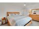 Bright primary bedroom with a large bed, light-colored walls, and ample natural light at 7784 Lewis St, Arvada, CO 80005