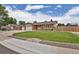 Beautiful home with a two-car garage, extra wide driveway, lush green lawn, and decorative rock landscaping at 7784 Lewis St, Arvada, CO 80005