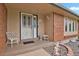 Charming front porch featuring a secure door, decor, and rock landscaping with a Welcome mat at 7784 Lewis St, Arvada, CO 80005