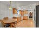Bright eat-in kitchen with wood cabinets, wood flooring, and lots of natural light at 7784 Lewis St, Arvada, CO 80005