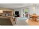Inviting living room with fireplace, comfortable seating, wood flooring, and sliding glass doors to backyard at 7784 Lewis St, Arvada, CO 80005