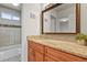 Bathroom featuring a granite countertop vanity and tiled shower at 246 S Newark Cir, Aurora, CO 80012