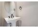 Small bathroom with pedestal sink, toilet and oval mirror at 2570 Josephine Way, Superior, CO 80027