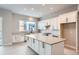 Spacious kitchen featuring white cabinets, a large island, and herringbone tile backsplash at 2570 Josephine Way, Superior, CO 80027