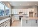 Modern kitchen with white cabinets, stainless steel appliances, and large windows at 2570 Josephine Way, Superior, CO 80027