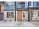 Orange door entrance to townhome with white stone exterior at 2570 Josephine Way, Superior, CO 80027