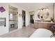 Bathroom featuring a soaking tub, glass shower, dual vanity and large closet at 5623 Raintree Dr, Parker, CO 80134