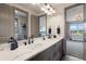 Elegant bathroom with a double sink vanity, marble countertop, and modern fixtures at 5623 Raintree Dr, Parker, CO 80134