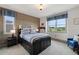 Stylish bedroom featuring a wood accent wall, a bed with built-in storage, and bright windows at 5623 Raintree Dr, Parker, CO 80134