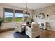Sun-filled breakfast nook with picturesque views and stylish chandelier at 5623 Raintree Dr, Parker, CO 80134