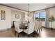 Formal dining room with large windows, decorative chandelier, and seating for eight at 5623 Raintree Dr, Parker, CO 80134