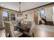 Elegant dining room featuring a modern chandelier, hardwood floors, and natural light at 5623 Raintree Dr, Parker, CO 80134