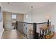 Upstairs hallway featuring stone accent wall, wood floors, and elegant lighting at 5623 Raintree Dr, Parker, CO 80134